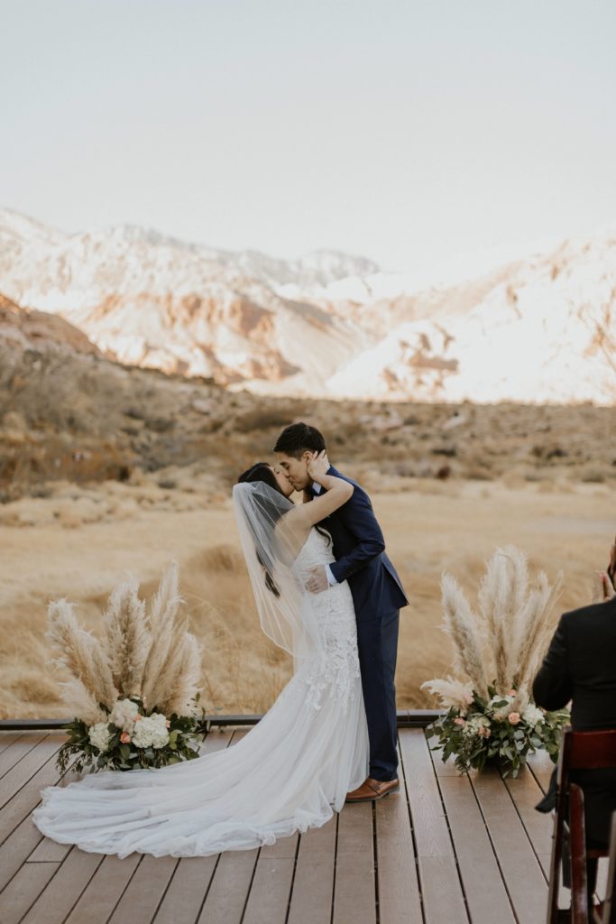 Newlywed couple sharing a kiss during their wedding shoot, captured by Las Vegas wedding photographer Emily Reno