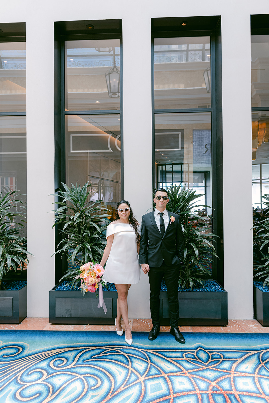 Places to Get Married in Vegas On The Strip (No Chapels); Bride and Groom posing outside a wedding venue in the Las Vegas strip captured by Elopement Las Vegas