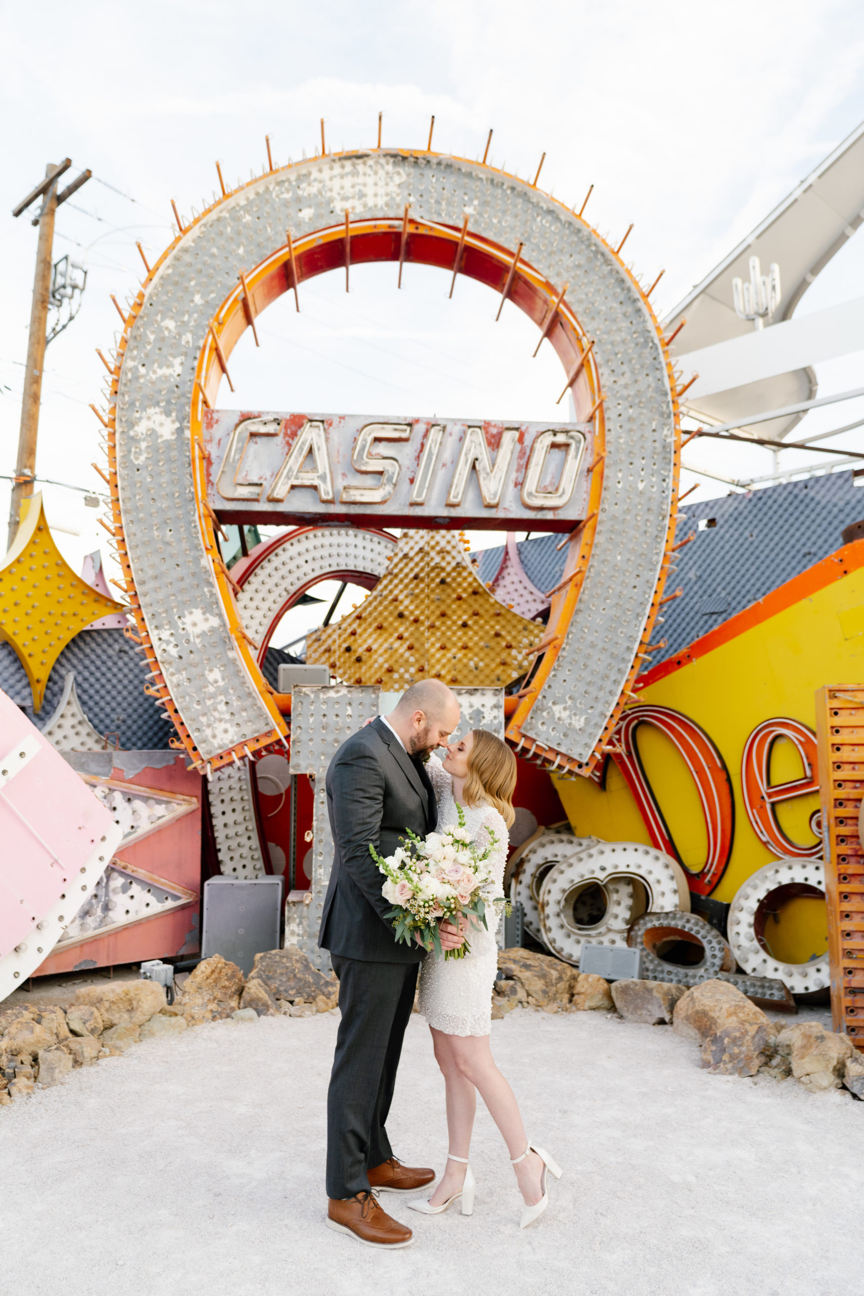 Couple posing together during their wedding shoot at the Neon Museum On the Strip