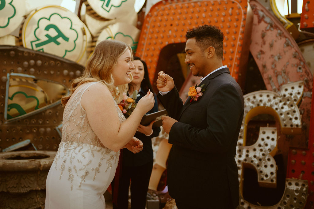 Couple smiling and holding up their rings at Just-Us-Two Neon Museum in Las Vegas