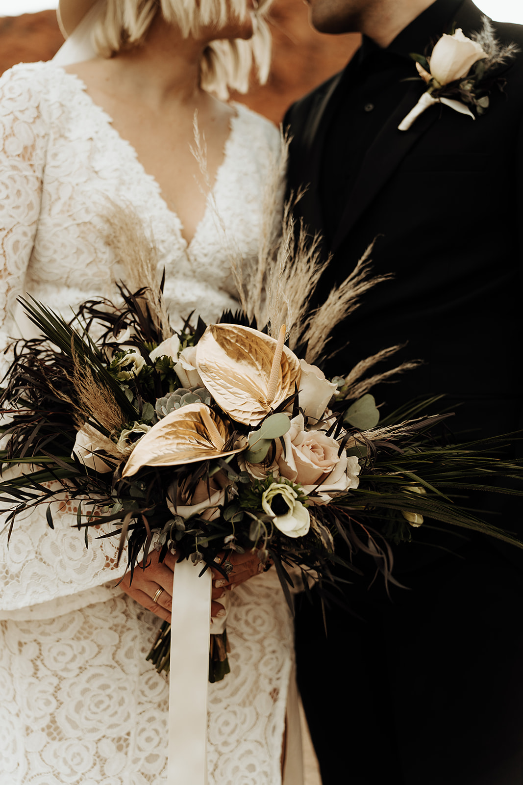 The Top All Inclusive Elopement Packages. Close up shot of bride and groom standing next to each other with bride holding her elegant bouquet.
