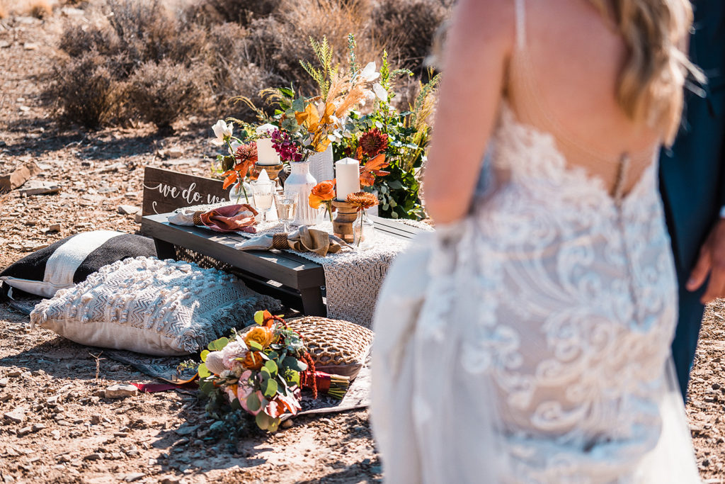 Bride and groom approaching their picnic layout set up by Elopement Las Vegas