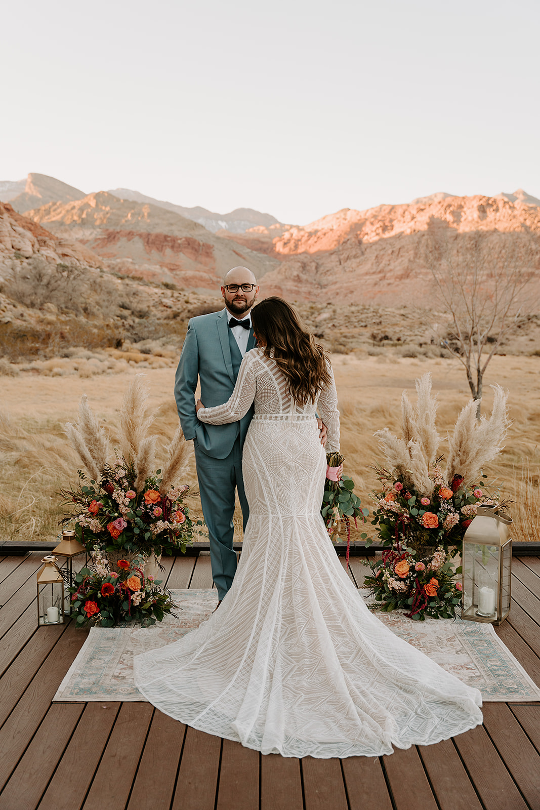 Couple posing with their decor and wedding ceremony setup designed by Elopement Las Vegas