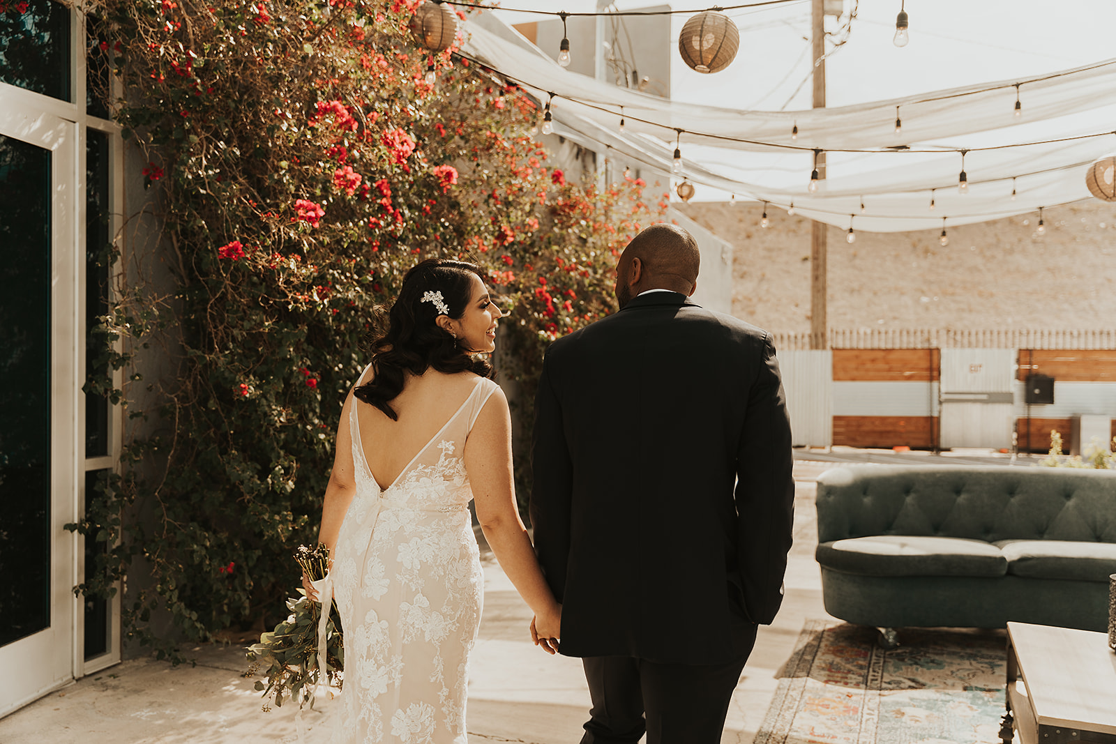 Bride and groom holding hands while walking together at wedding venue in Las Vegas