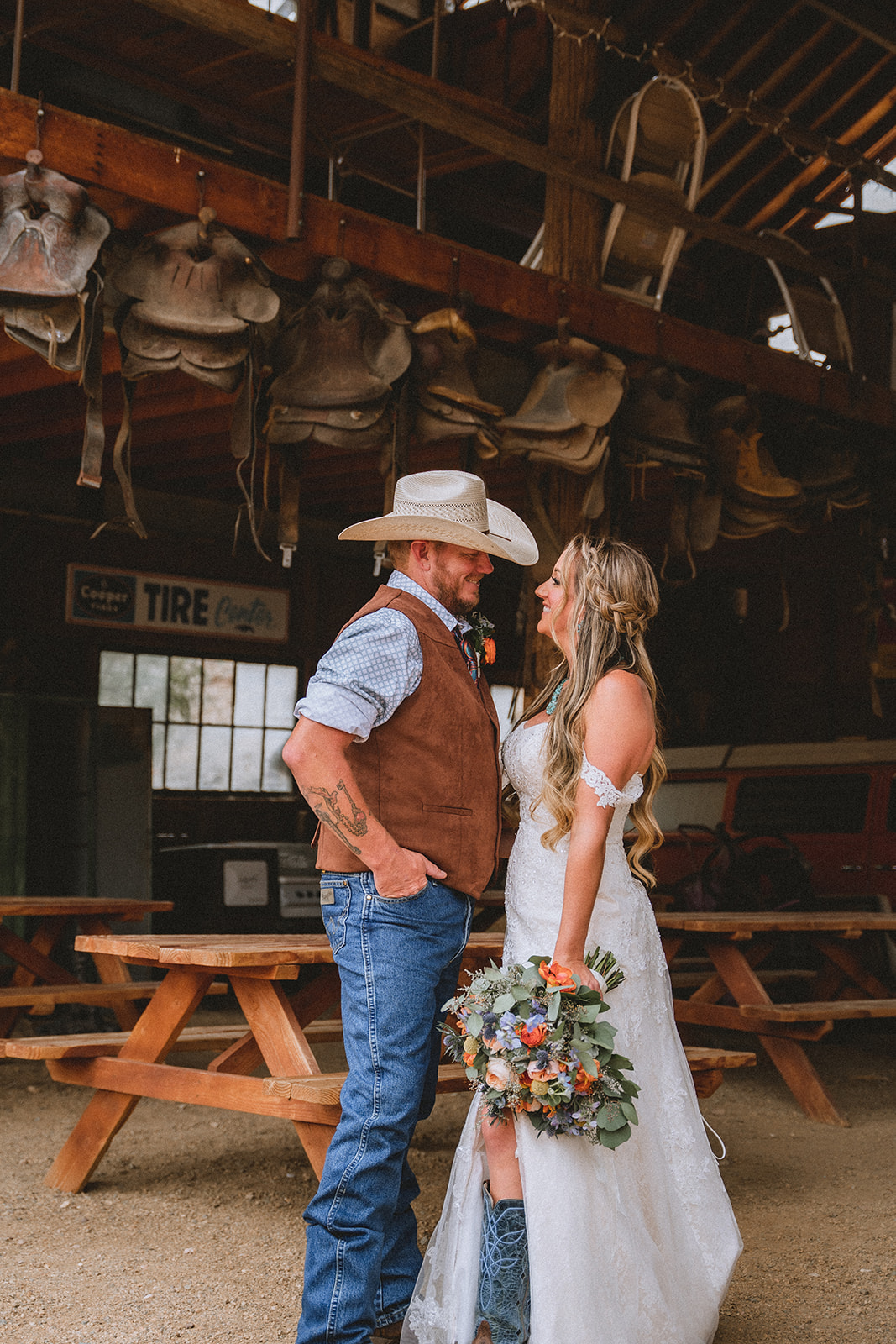 Couple smiling at each other as they pose at the rustic barn in Nelson Ghost Town Las Vegas
