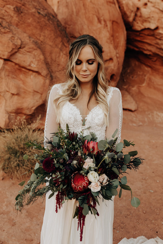 Bride posing with her beautiful floral bouquet for their Las Vegas elopement