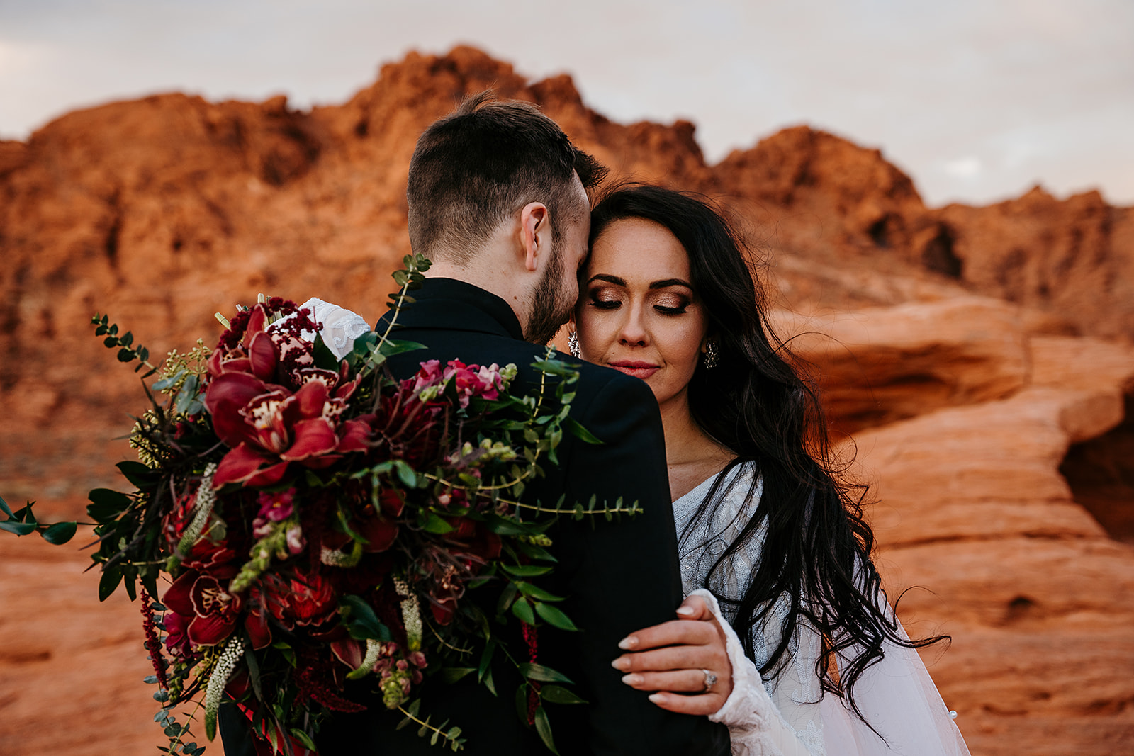 Valley of Fire Weddings - All-Inclusive Elopement Packages. Couple sharing an embrace during their Valley of Fire wedding shoot.