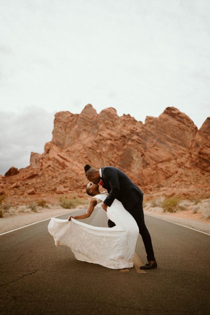 Bride and groom share a kiss during their fine art elopement shoot coordinated by Elopement Las Vegas