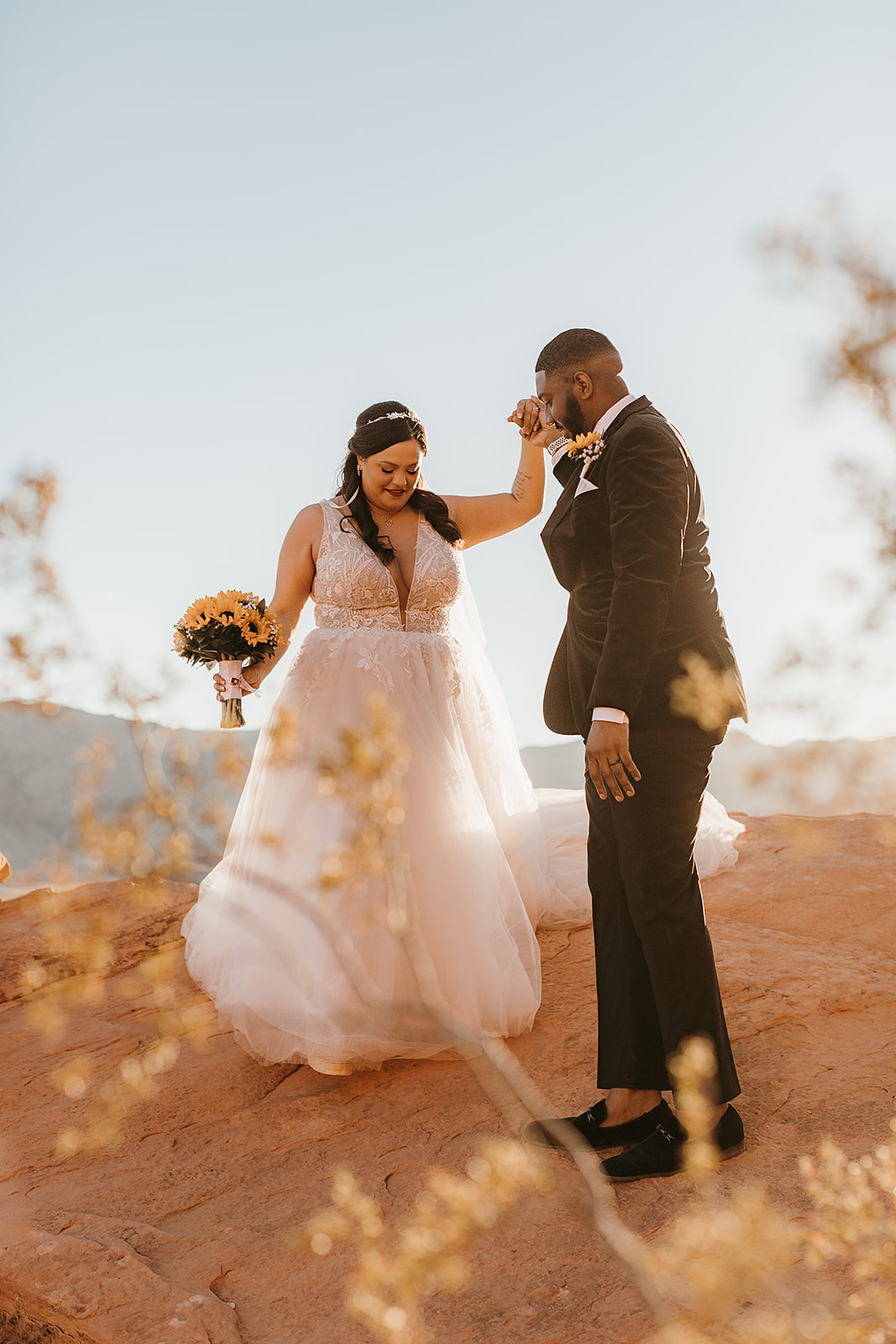 Valley of Fire Wedding & Elopement Planning Guide. Bride and groom posing candidly for their elopement shoot.