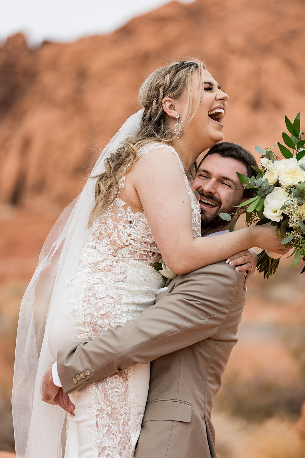 Valley of Fire Wedding & Elopement Planning Guide. Groom lifting up bride as they both smile.