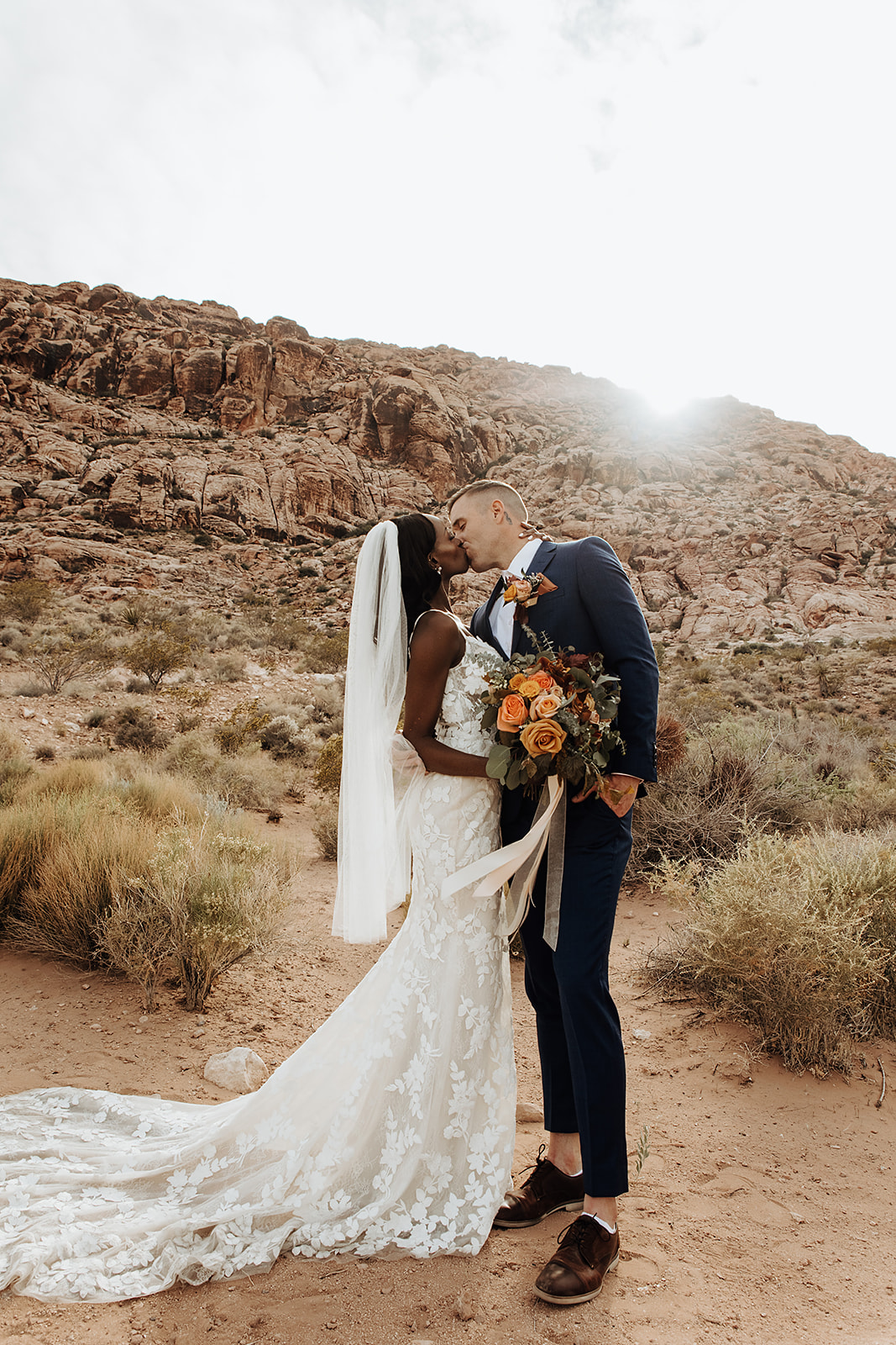How To Plan The Perfect Red Rock Canyon Elopement (Las Vegas). Newlywed couple sharing a kiss during their elopement ceremony.