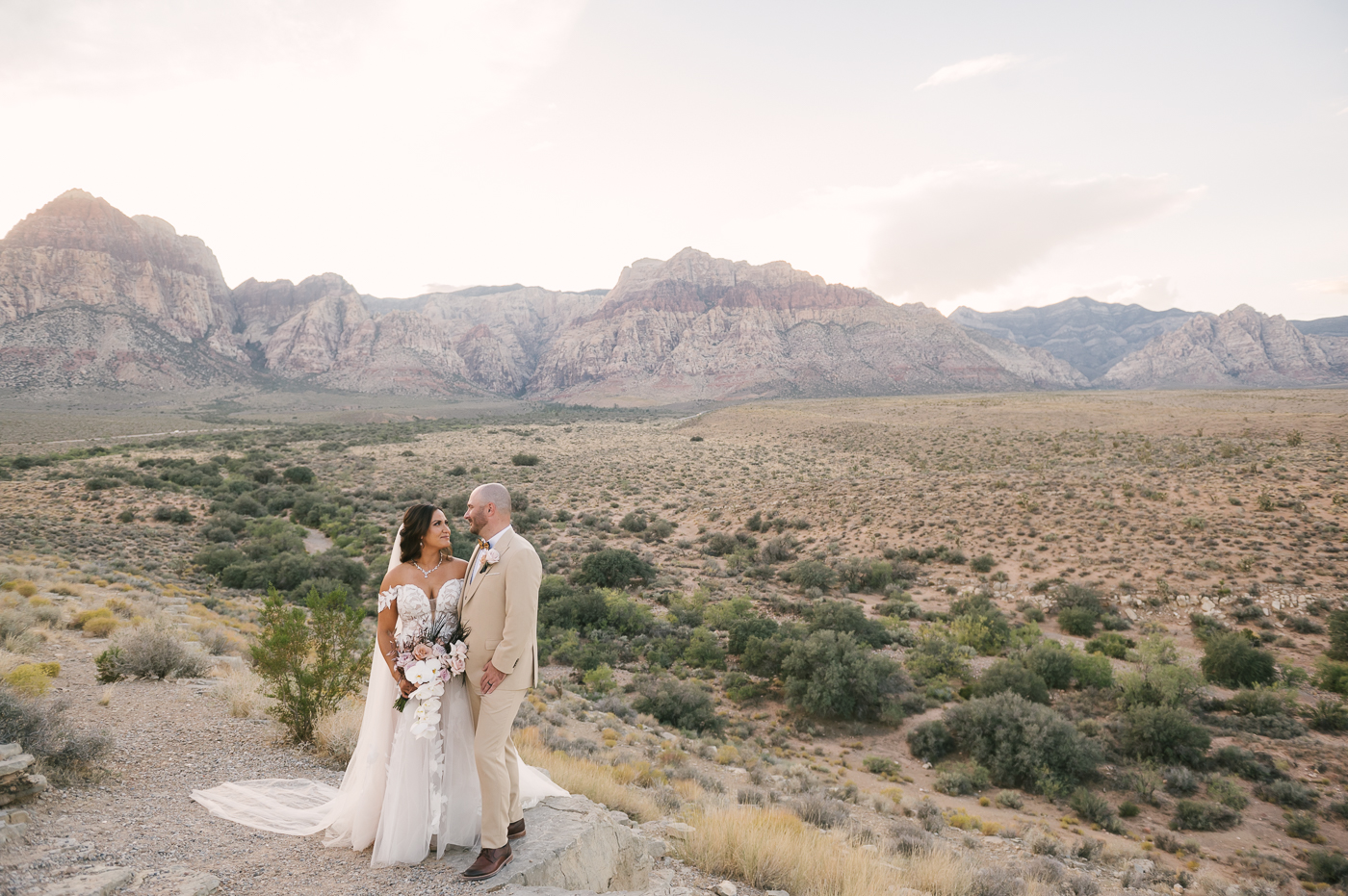 Bride and groom smiling at each other endearingly during their elopement shoot coordinated by Elopement Las Vegas