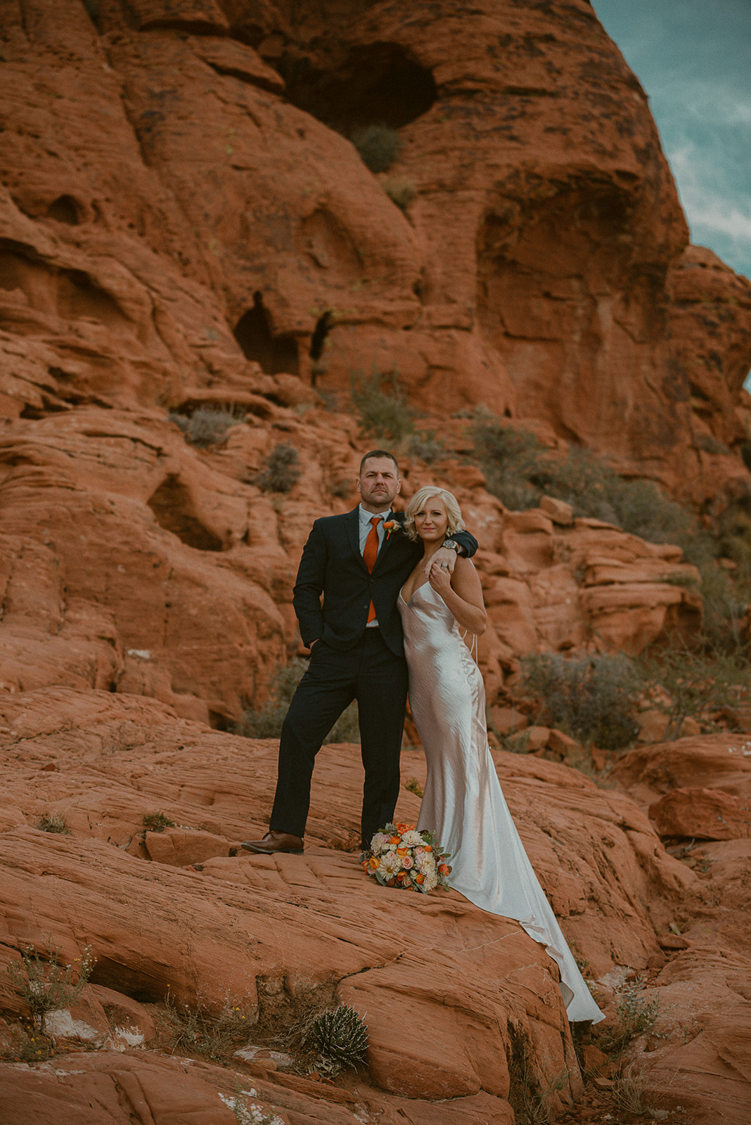 Bride and groom posing for the camera during their Red Rock Canyon elopement shoot