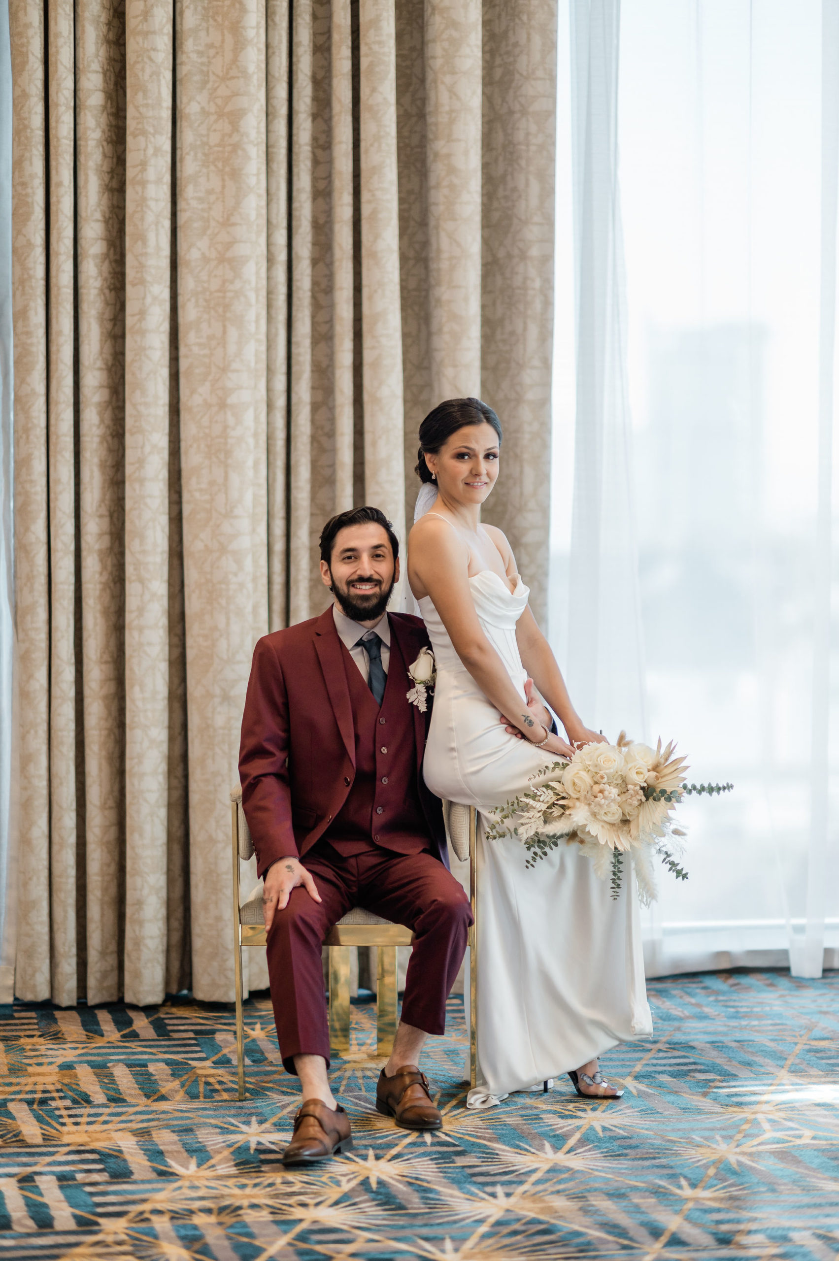Couple posing as they sit on a chair during their Las Vegas wedding arranged by Elopement Las Vegas