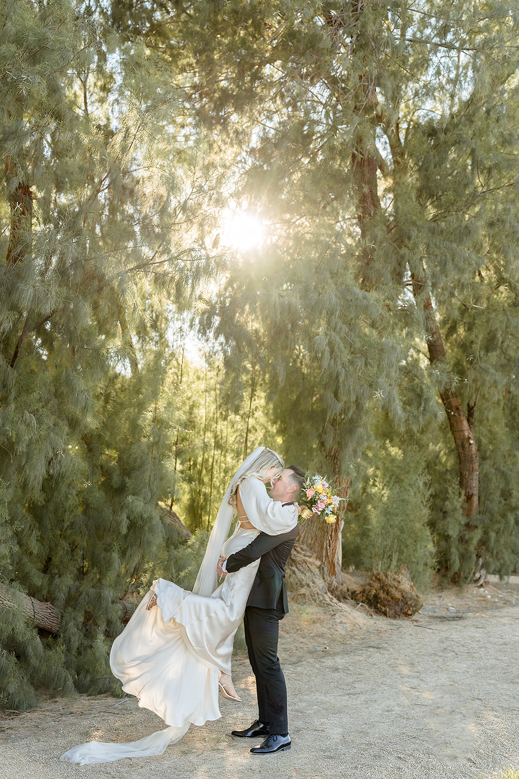 Groom lifts bride up during their wedding shoot at GreenGale Farms arranged by Elopement Las Vegas