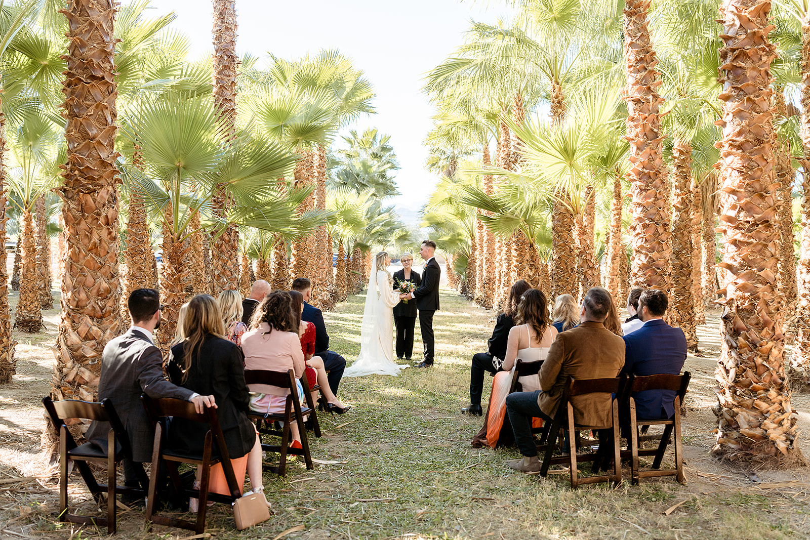GreenGale Farms All-Inclusive Elopement Packages. Wedding ceremony with guests sitting on wooden chairs.