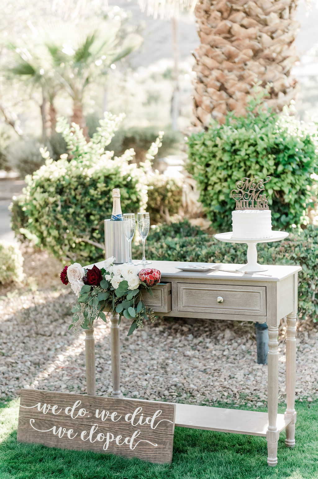 Red Rock Country Club Wedding: A Complete Guide. Champagne, wedding cake, and signage set up by Elopement Las Vegas.