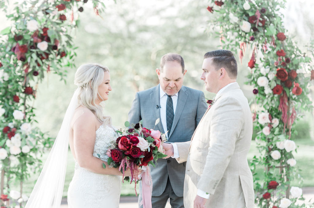 Couple standing in front of officiant during their Red Rock Country Club wedding ceremony