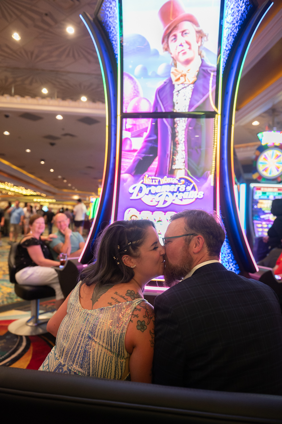 Bride and groom sharing a kiss inside casino during their wedding shoot in Las Vegas Boulevard