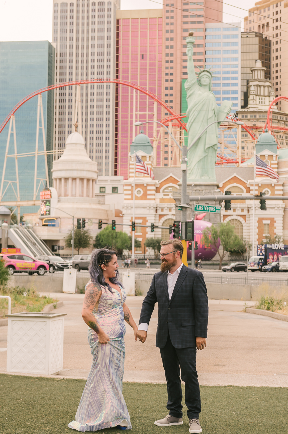 Newlywed couple holding hands and smiling at each other in Las Vegas Boulevard