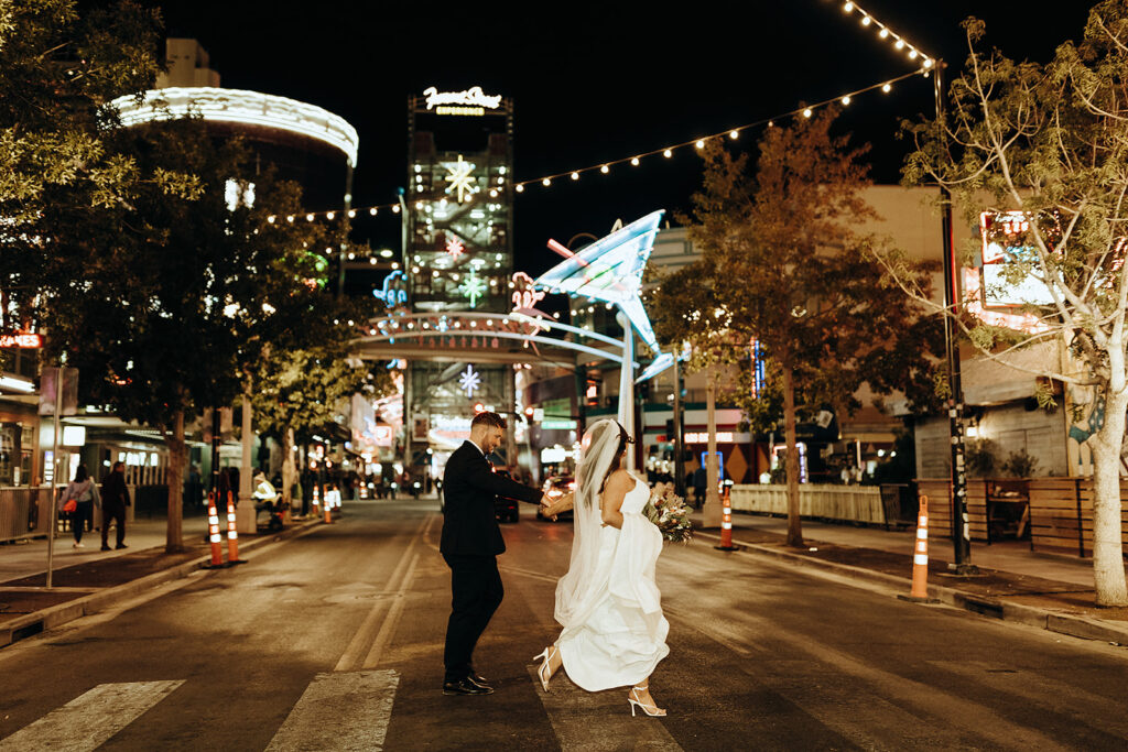 Newlywed couple crossing the street candidly during wedding shoot organized by Elopement Las Vegas