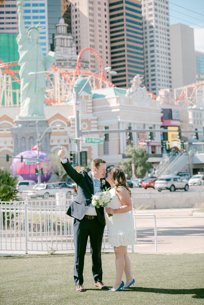 Bride and groom leaning in for a kiss during their wedding shoot in Las Vegas Boulevard