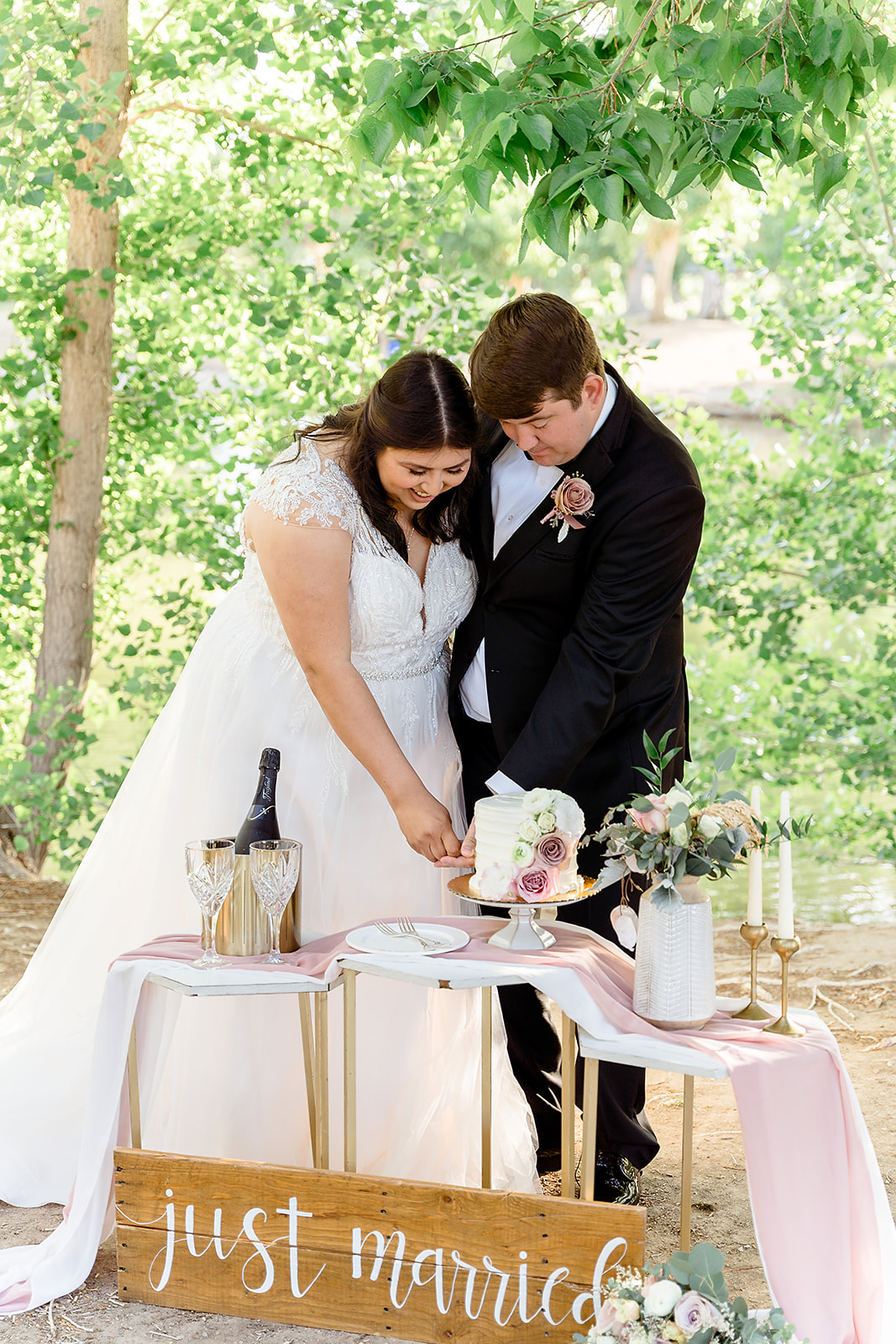 The Ultimate Tule Springs Wedding and Elopement Planning Guide. Couple cutting a slice of their wedding cake together.