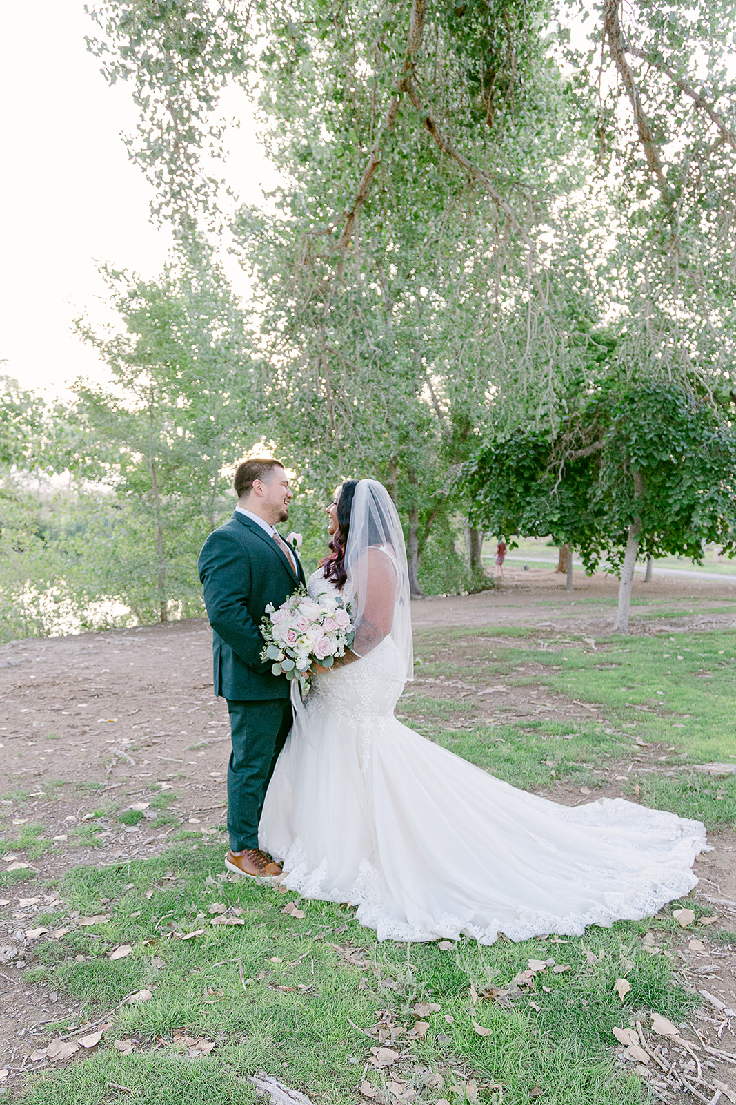 Bride and groom laughing candidly with each other during their Tule Springs wedding shoot