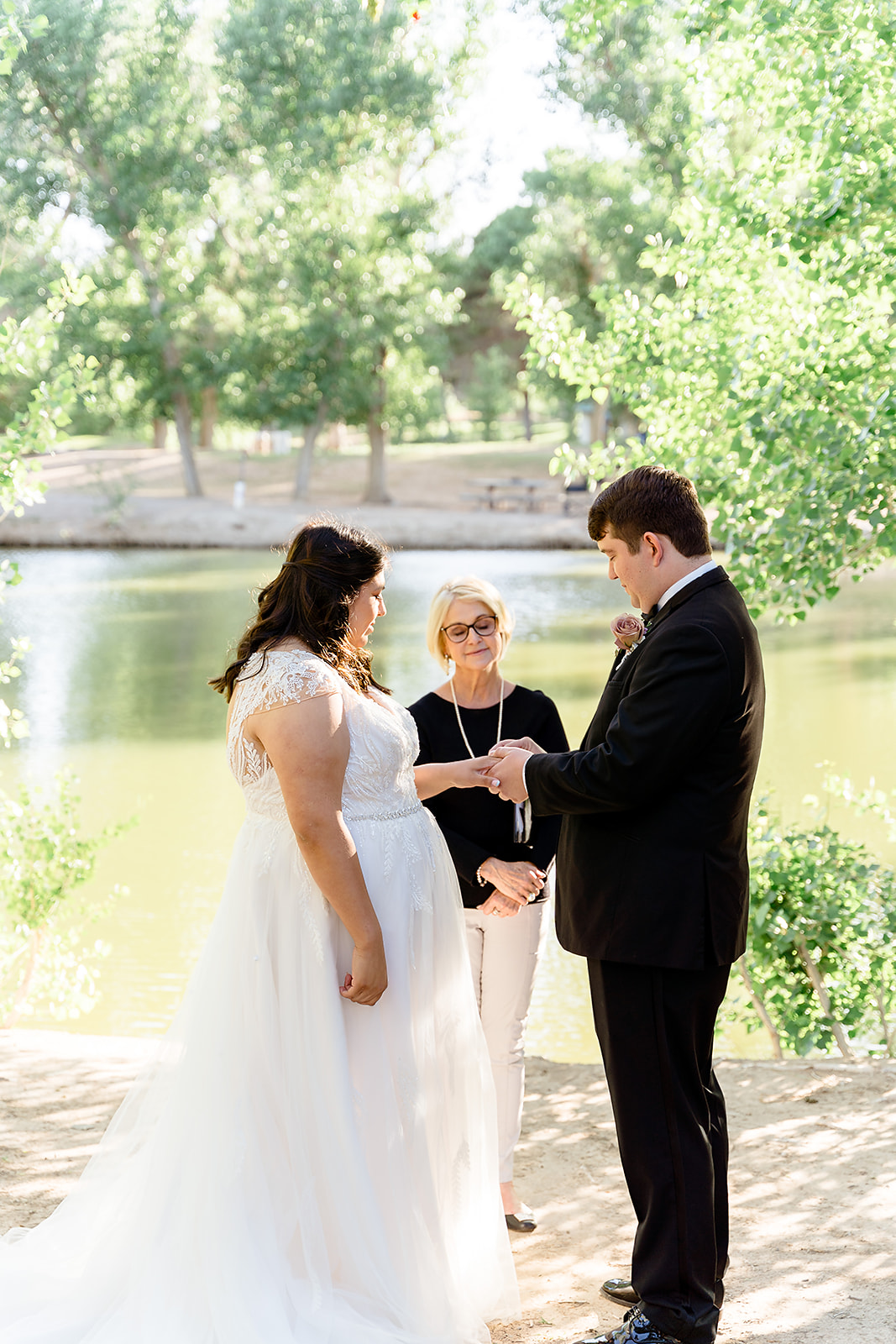 Bride and groom standing before officiant during their elopement arranged by Elopement Las Vegas