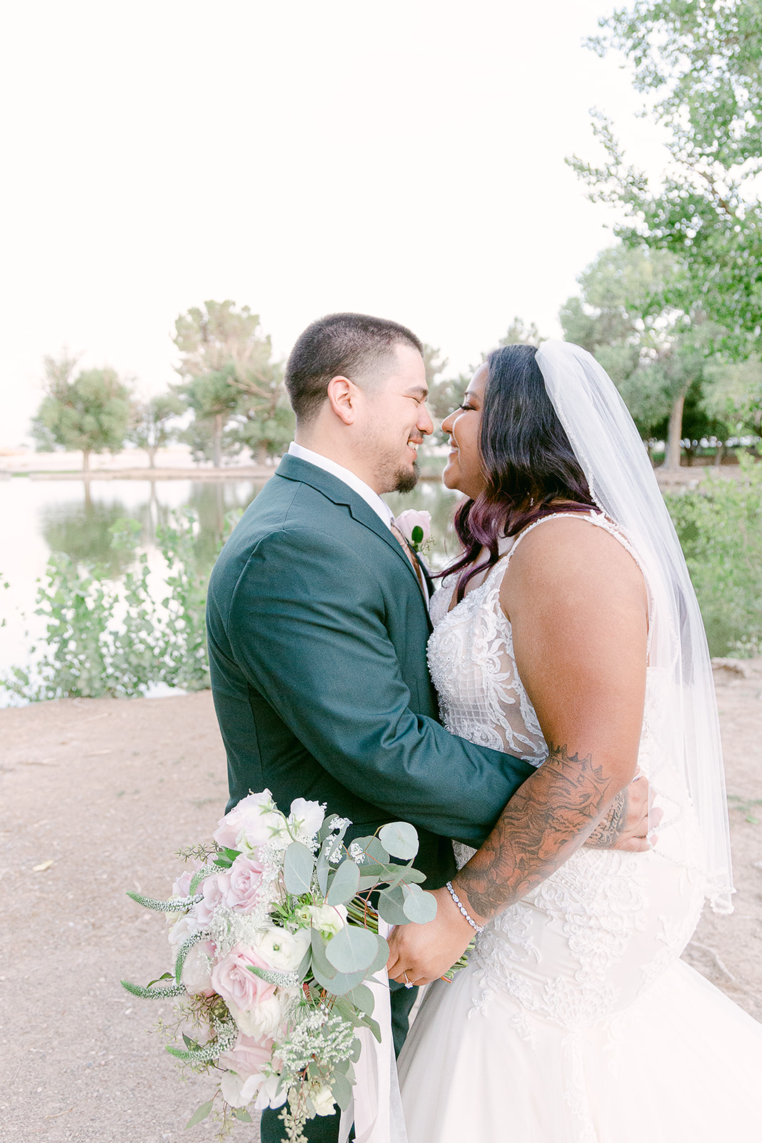 Bride and groom laughing candidly as they share an embrace during their elopement shoot at Tule Springs