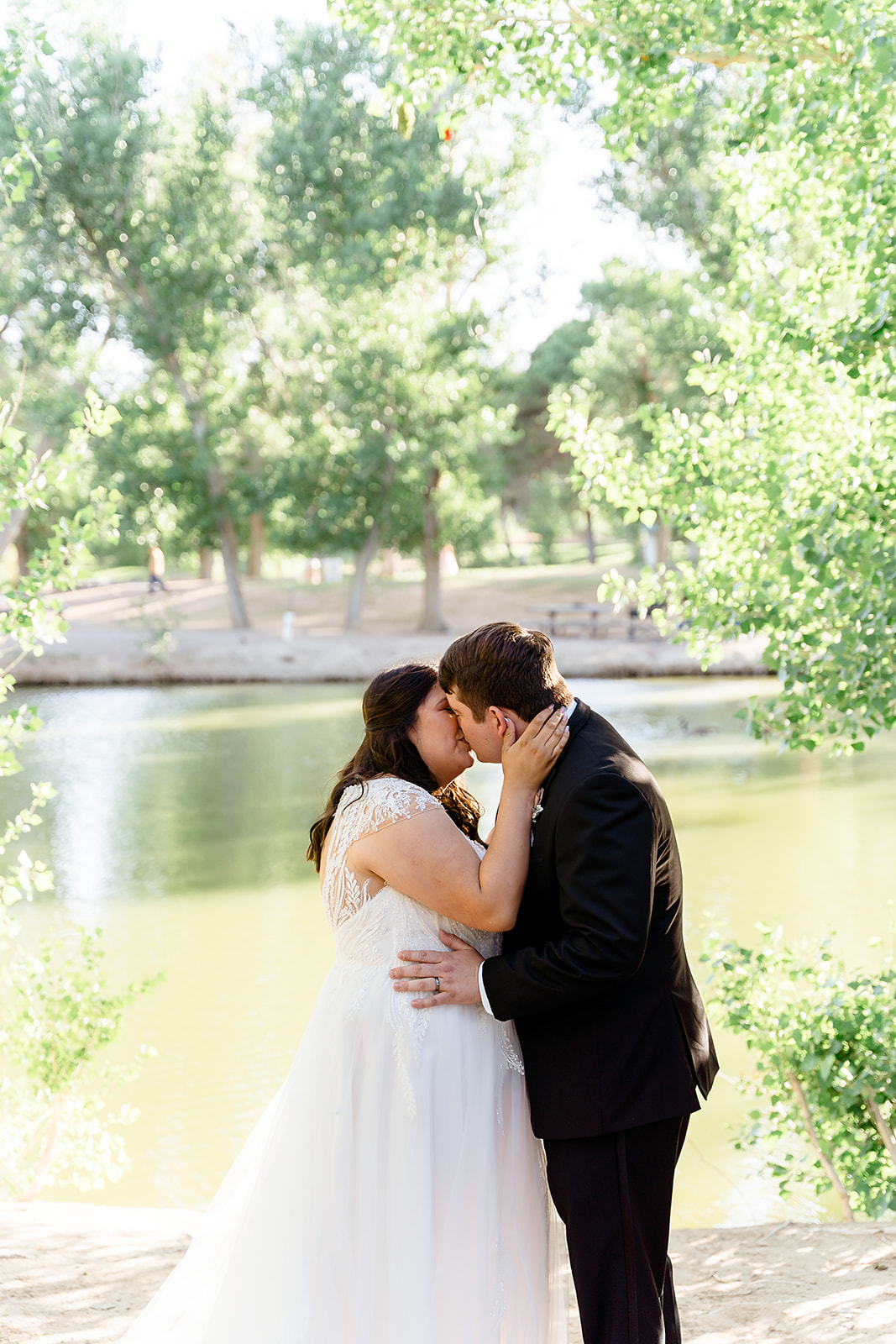 The Ultimate Tule Springs Wedding and Elopement Planning Guide. Couple sharing a kiss in front of lake during their elopement.