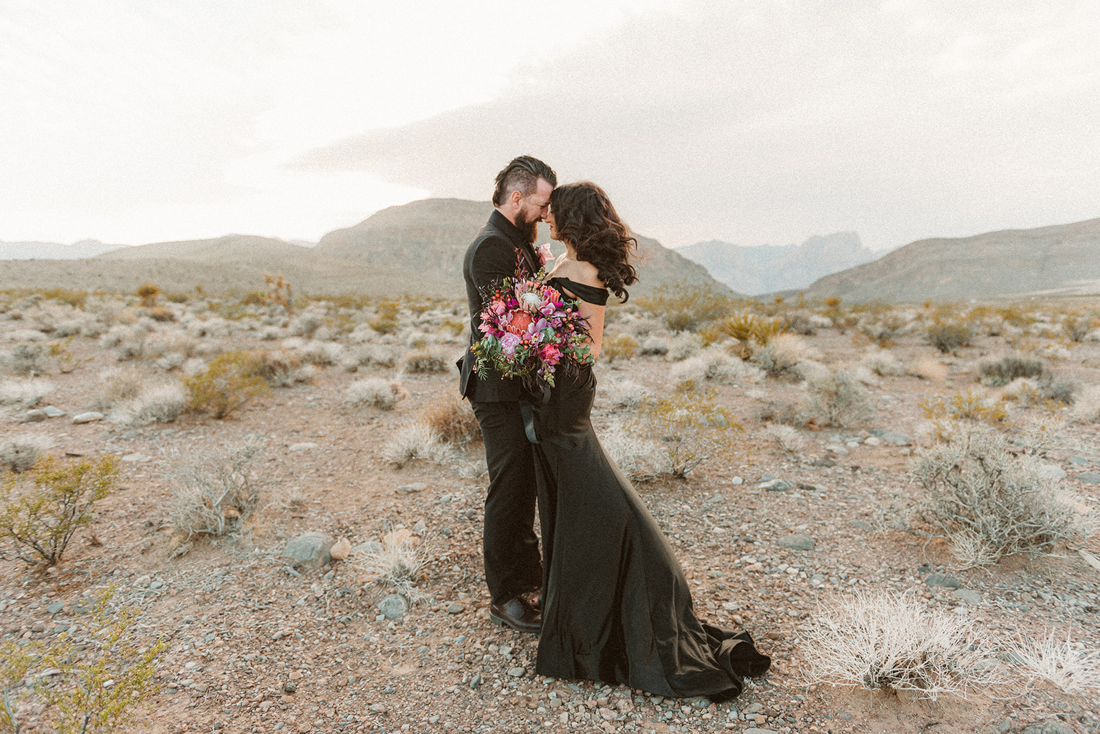 Bride and groom sharing an embrace during their black-themed elopement in Las Vegas