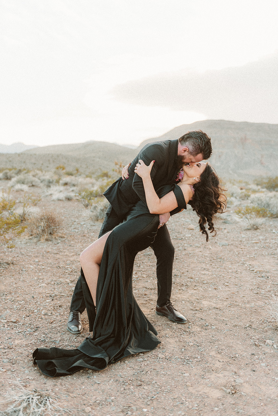 Groom dipping the bride as they lean in for a kiss during their elopement shoot in Las Vegas