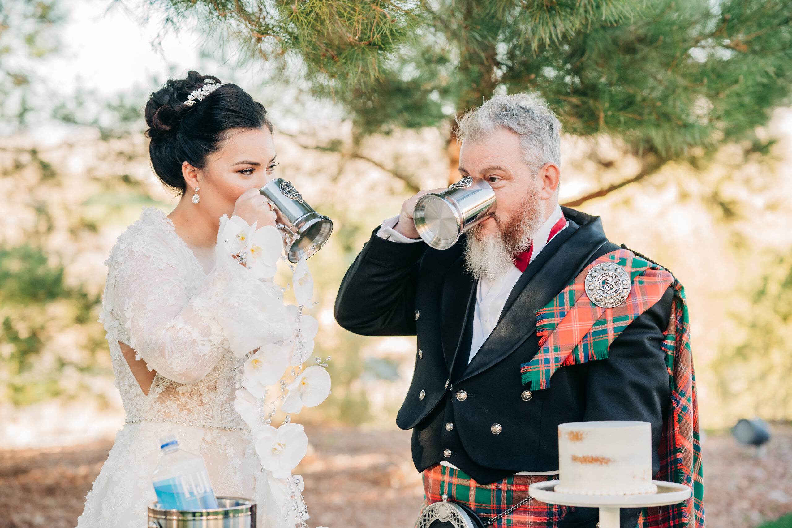 Bride and groom drinking from silver cups during their elopement shoot