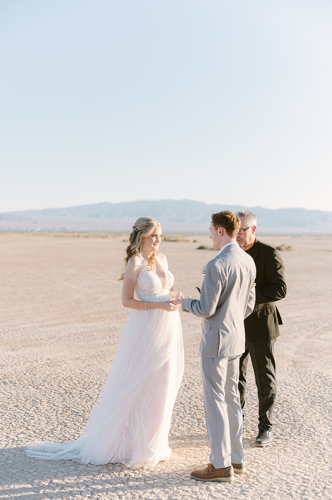 Bride smiles at the groom during their elopement ceremony organized by Elopement Las Vegas