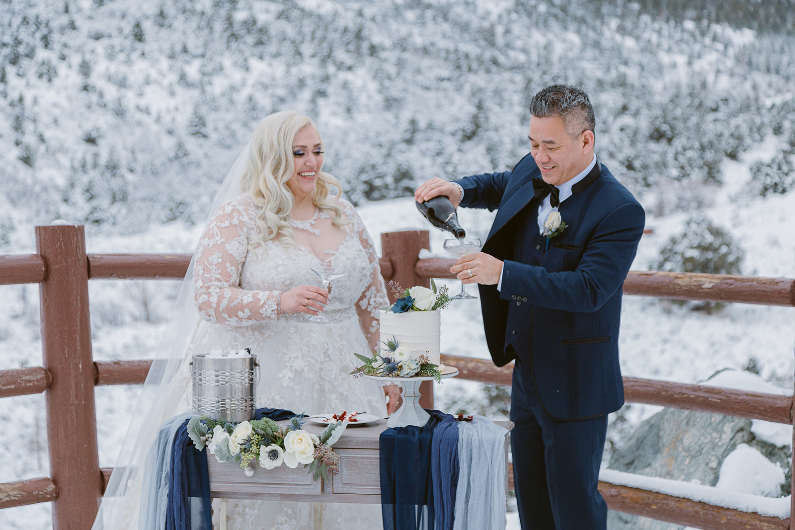 Groom pouring champagne into glass with bride standing next to him during their elopement in Las Vegas