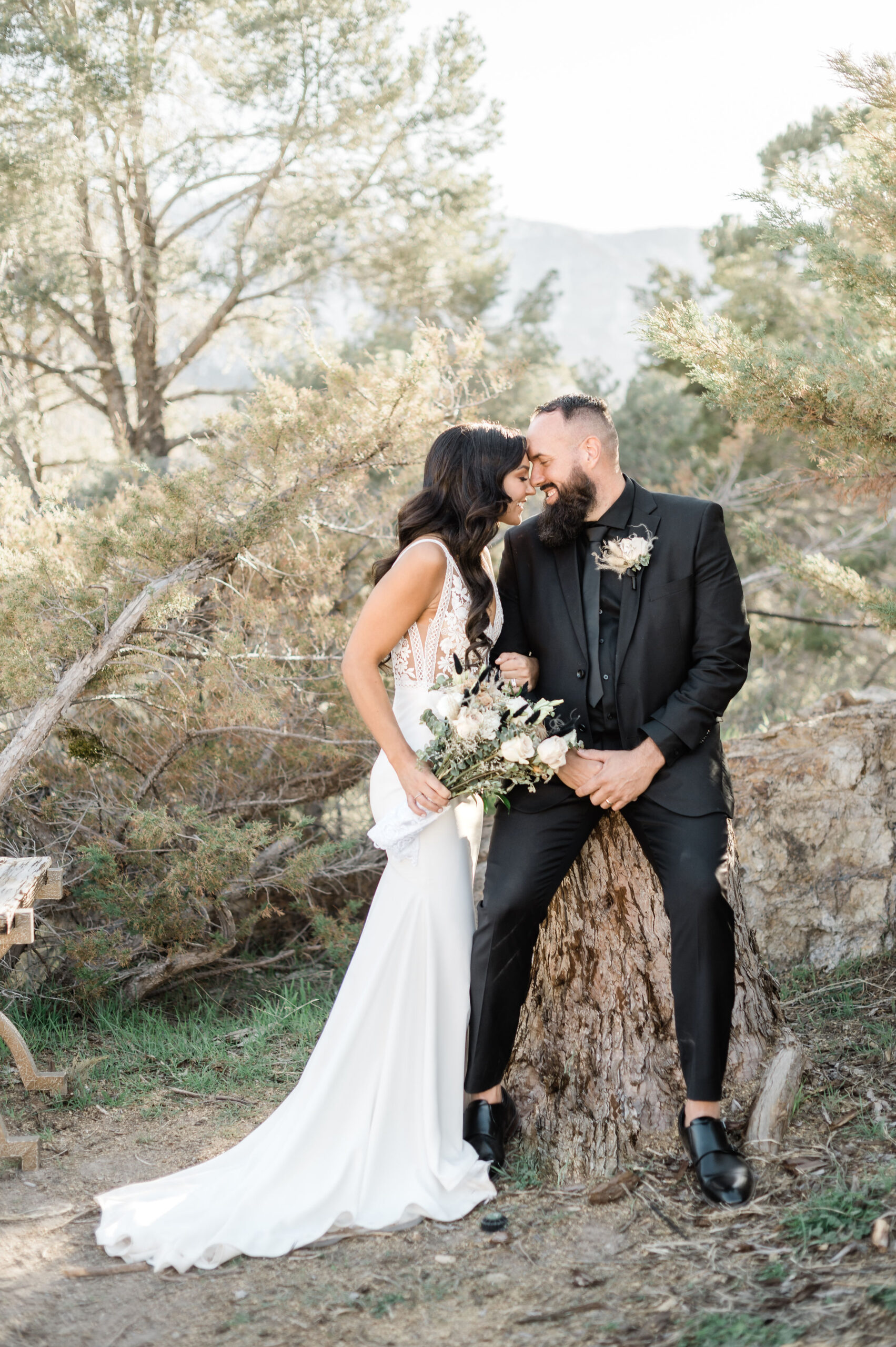 Bride and groom pressing their foreheads against each other as they smile during their Mount Charleston wedding shoot