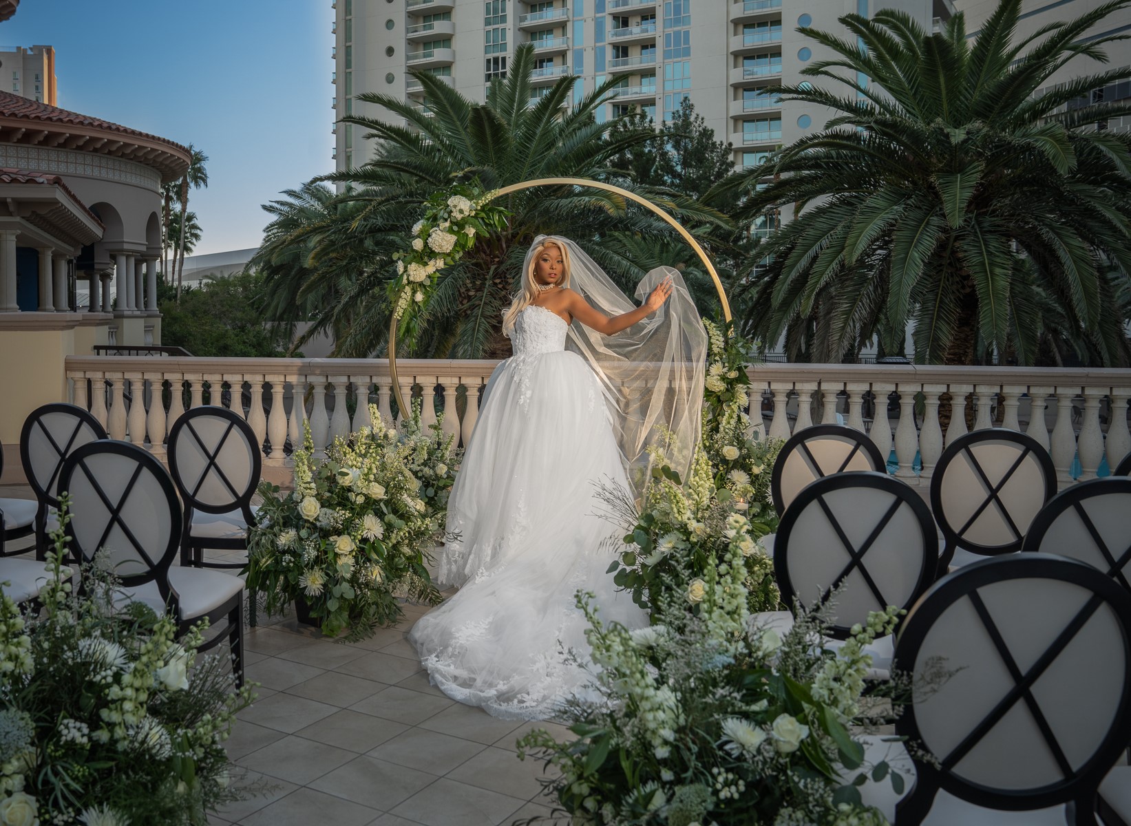 Everything You Should Know about Eloping at The Stirling Club. Bride posing in front of wedding arch at the venue.