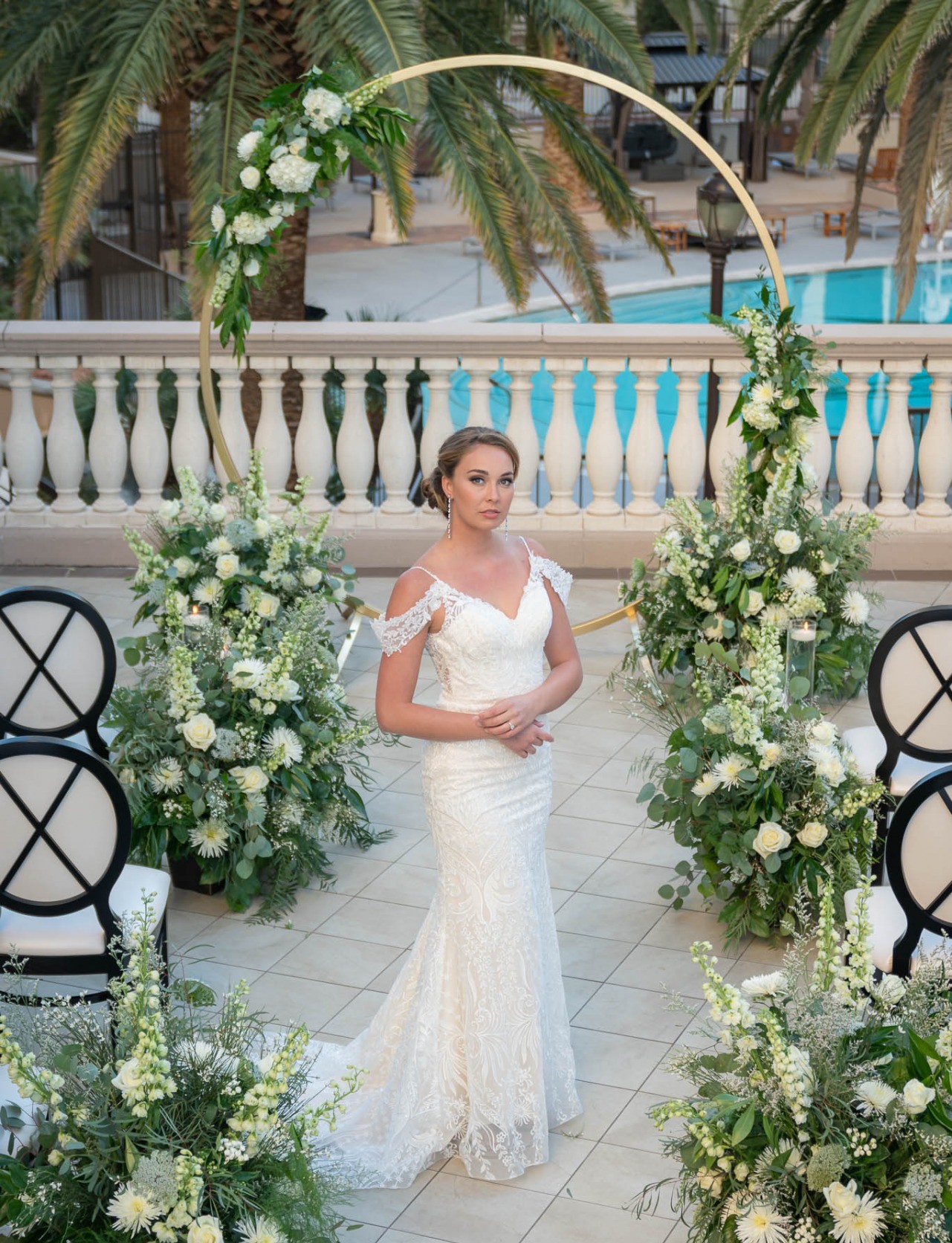 Everything You Should Know about Eloping at The Stirling Club. Bride posing in front of wedding arch in her wedding dress.